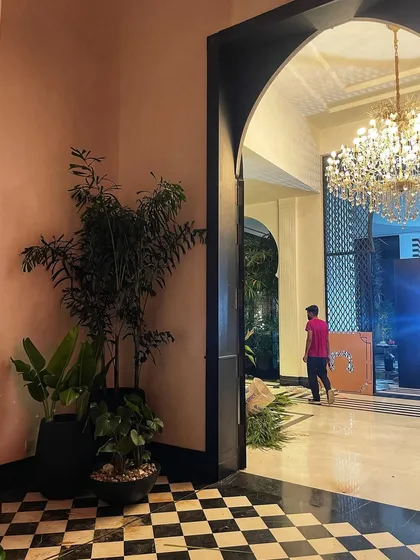 Another view of the interior set, showing how the plant arrangements help define the space and add a layer of luxury to the production design.