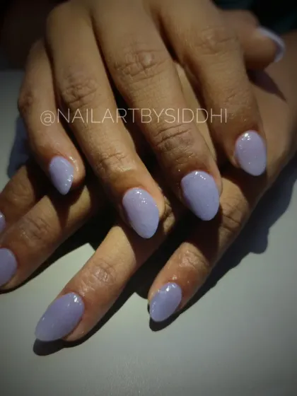 A nail strengthening service with a beautiful lavender gel polish, helping natural nails grow long and strong.