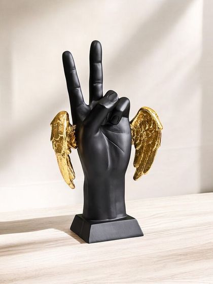 This modern showpiece features a hand making a peace sign, with golden wings attached. It's a unique and symbolic piece that represents peace and freedom in a contemporary style.