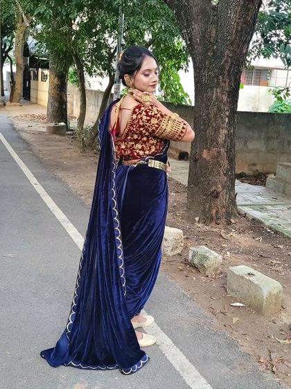 An outdoor shot of the velvet dhoti drape, showing how the rich fabric and unique style make a powerful statement.