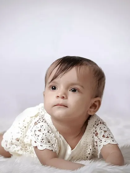 A simple, beautiful portrait of a baby on a clean white background. These classic shots highlight your baby's natural curiosity and charm.