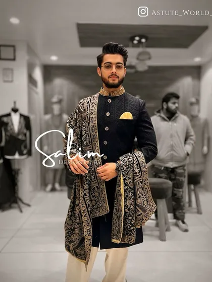 A client wearing a black Indo-Western jacket with a matching embroidered pashmina shawl. This is a perfect example of how I style a complete, cohesive look.