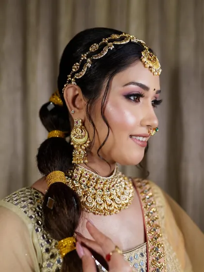 A happy client is my biggest reward. Here is a beautiful bride looking radiant for her function in one of my gold-finish kundan choker sets, complete with a matha patti and matching earrings.