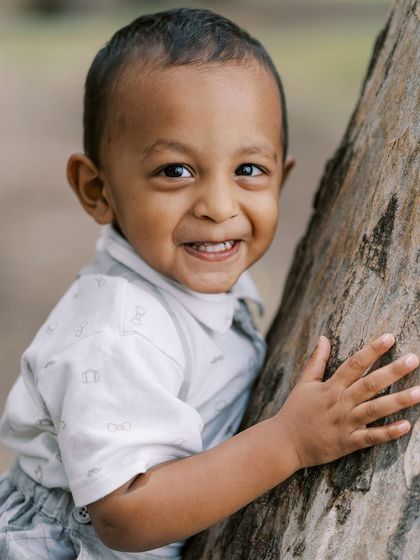 A close-up of a happy two-year-old boy. His bright smile is a testament to a fun and engaging photoshoot.