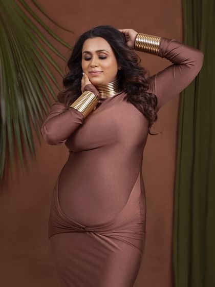 A soft and serene close-up, highlighting her beautiful makeup and the peaceful expression of motherhood.