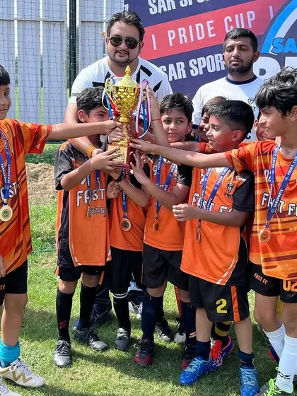 Our U8 team proudly displays their runners up trophy from the Pride Cup. We believe in introducing young players to competitive football early to build confidence and fundamental skills from the ground up.