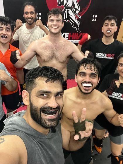 A fun selfie after a tough training session. The smiles and playful poses show the strong bonds formed on the mat.