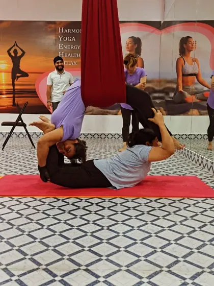 Another angle of a complex aerial Acro Yoga pose, showing the strength and flexibility required. My role is to guide and support the students through the sequence.