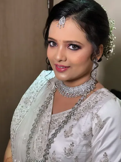A smiling portrait of the reception look. The makeup is flawless and the diamond jewellery adds a touch of modern glamour.