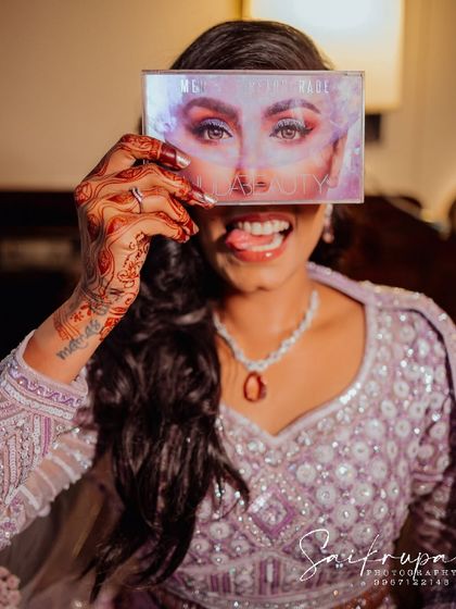 A fun and quirky photo of the bride during her getting-ready session. These playful, behind-the-scenes shots add so much personality to your final gallery.