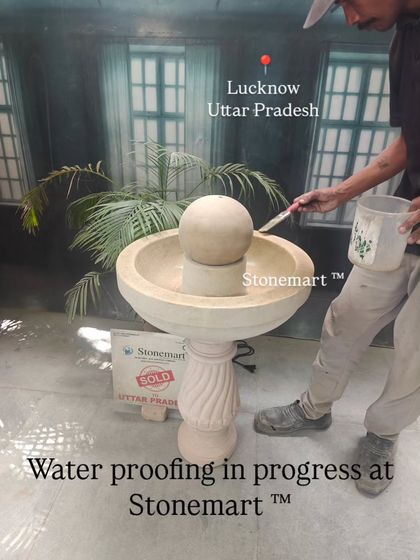 Waterproofing is a crucial step. Here, a special sealant is being applied to a medium-sized modern stone fountain to ensure it is completely leak-proof before being packed for a client in Lucknow.