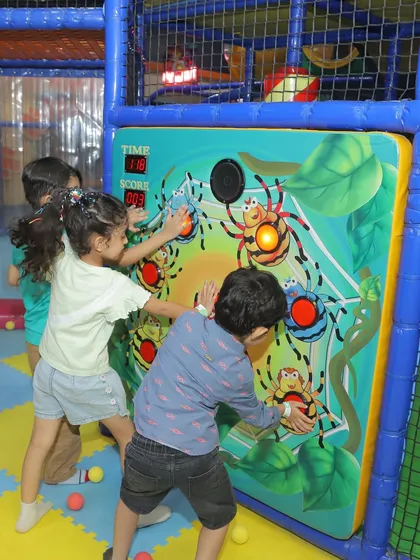 Kids work together on one of our interactive electronic wall games. These games are part of our My Maze structure and are a popular activity during birthday parties.