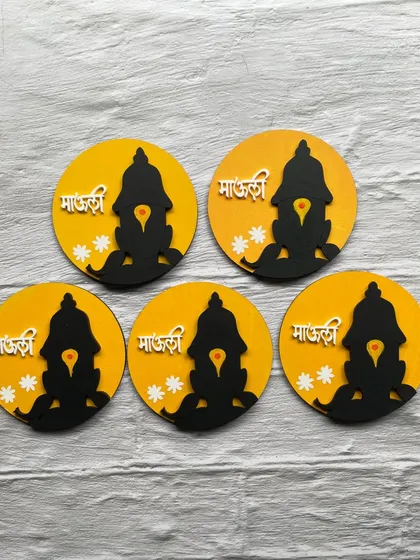 These 'Mauli' magnets, featuring the silhouette of Lord Vitthal, are a simple yet beautiful expression of faith. The yellow background is bright and cheerful.
