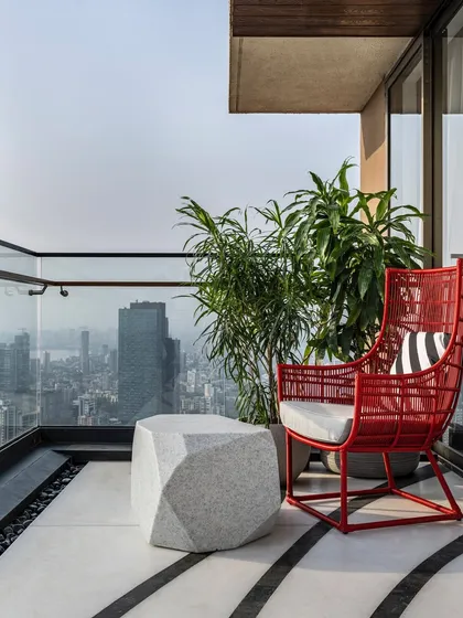 The ultimate luxury is a view that takes your breath away. Perched on the 45th floor, this penthouse balcony is a private escape with an unparalleled 180-degree vista of Mumbai's skyline and coast. It’s a space I designed for quiet reflection, high above the city's hum.