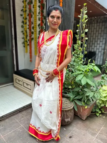 The quintessential Bengali look for Durga Puja, featuring the white saree with a simple red border. I guide my students on how to create the neat box pleats that are characteristic of this style.