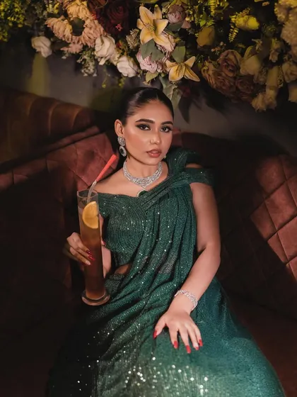 A relaxed moment during the shoot. Even while sipping a cocktail, she looks effortlessly glamorous.