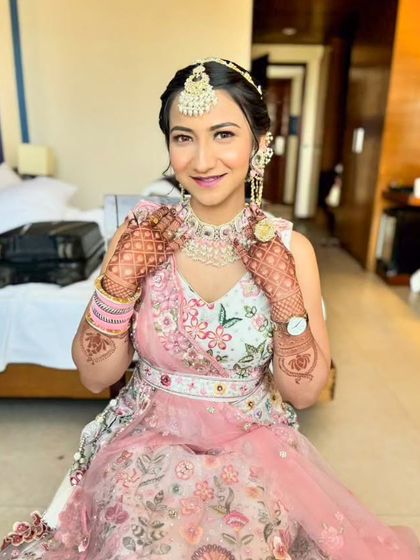 A lovely party makeup look in a pastel pink and white lehenga. The makeup is soft and romantic, perfect for a daytime event.