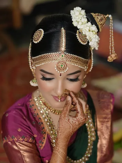A close-up of a traditional Iyengar bridal look. Notice the precision in the eyeliner, the soft skin finish, and how the makeup perfectly complements the intricate hair jewelry. It’s all about creating a harmonious and divine look for the main ceremony.