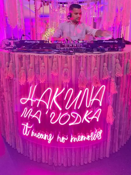 Fun and quirky decor like this "Hakuna Ma'Vodka" neon sign adds a playful touch to a cocktail party or sangeet night, setting a relaxed and fun tone.