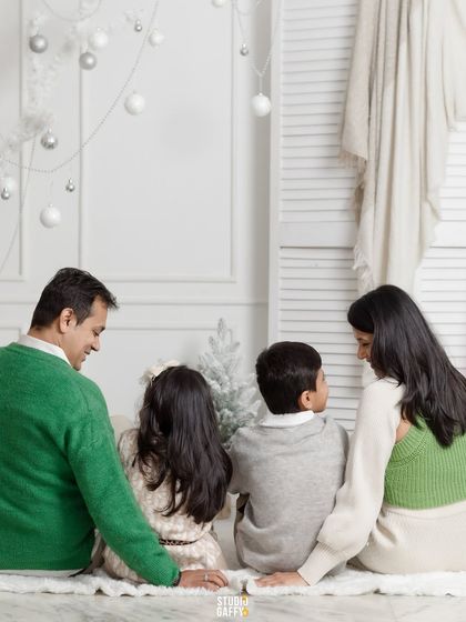 A quiet moment from behind, this family of four shares a peaceful moment in the white wonderland set.