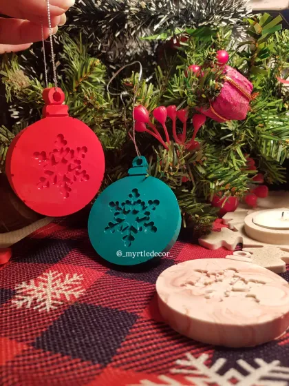 Our handmade Jesmonite ornaments hanging from a small tree. We designed them to be lightweight enough for delicate branches, adding a pop of modern, handcrafted charm.