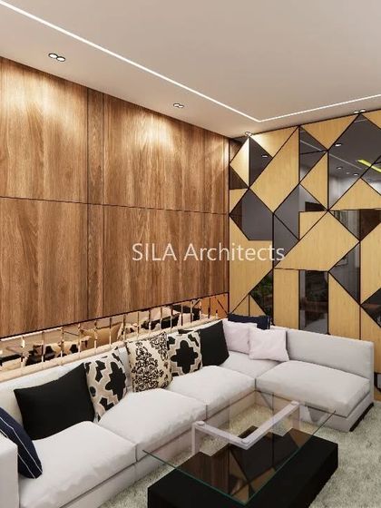 A living room concept for our Vizag project, showcasing a geometric partition and wood-paneled walls. This demonstrates our ability to design for clients across different cities.
