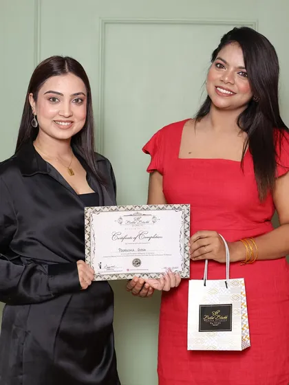 A student receiving her certificate and goodie bag. This marks the beginning of her professional journey.