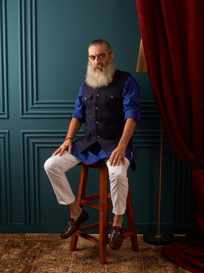 A bold and stylish combination of a royal blue kurta with a navy multi-pocket utility vest. This is a modern, functional take on traditional layering.