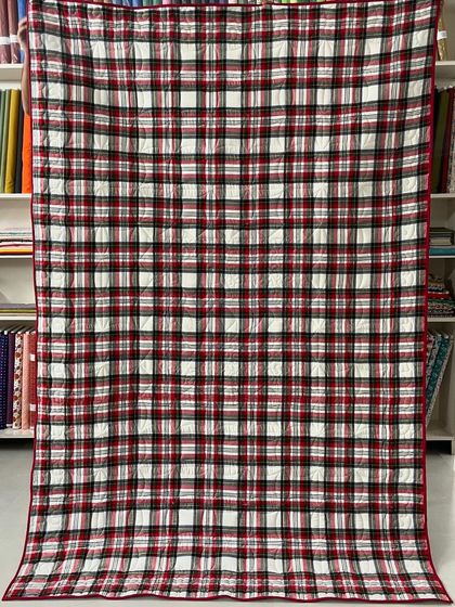 The back of the dachshund T-shirt quilt, featuring a classic red and black plaid flannel for extra warmth and a traditional look.