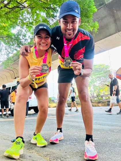 Posing with a friend and fellow runner after the TCS10K. The running community is all about celebrating each other's achievements.