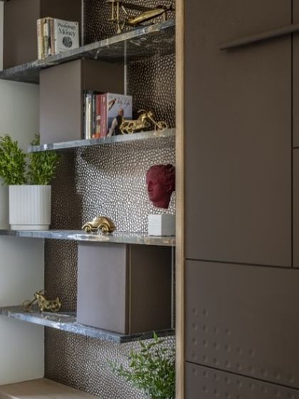 Our ‘Emerald Enchantment’ bookshelf features luxurious green marble shelves that add a touch of opulence. Hidden within are small storage spaces, proving that even elegant pieces can hold surprises.