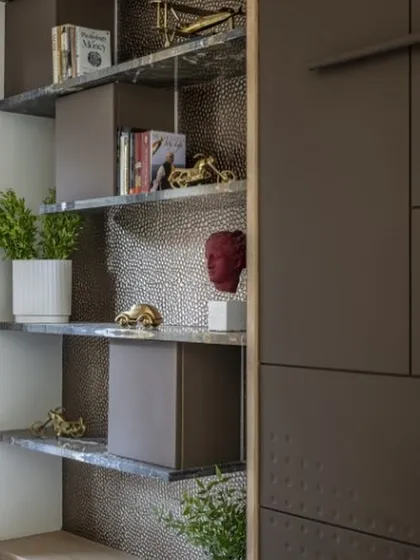 Our ‘Emerald Enchantment’ bookshelf features luxurious green marble shelves that add a touch of opulence. Hidden within are small storage spaces, proving that even elegant pieces can hold surprises.