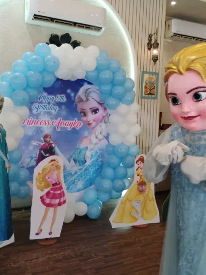 The Elsa mascot adds an interactive and lively element to the party decor.