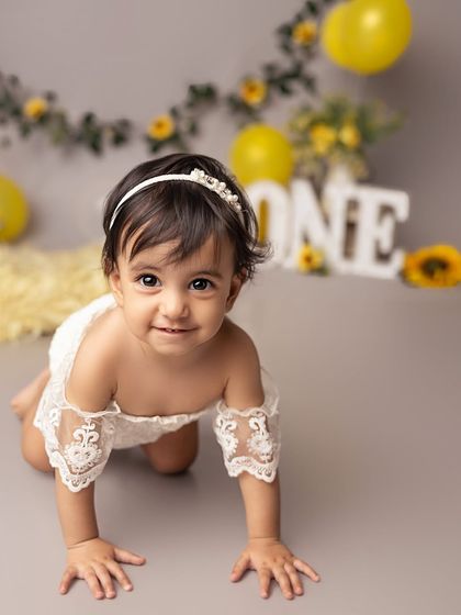 On the move and ready for cake! Capturing crawling shots during a first birthday session adds a dynamic and playful element that truly represents this active stage.