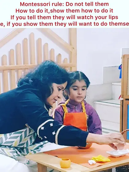 Our guiding principle is "Show them, don't tell them." In our prepared environment, a teacher gently demonstrates a practical life activity, allowing the child to observe and learn through action, not just words. This fosters deep concentration and a love for learning.