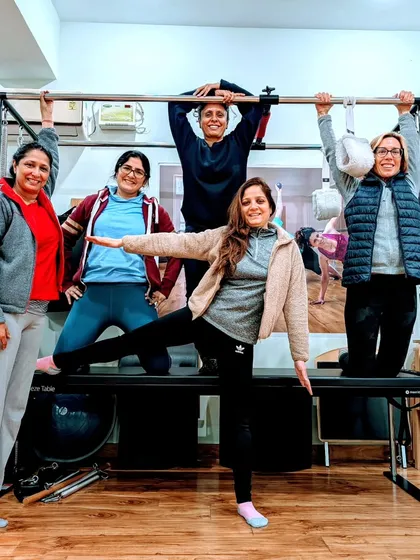 Posing and having fun on the Pilates Cadillac after a great session. It's moments like these that turn a workout into a truly joyful experience.