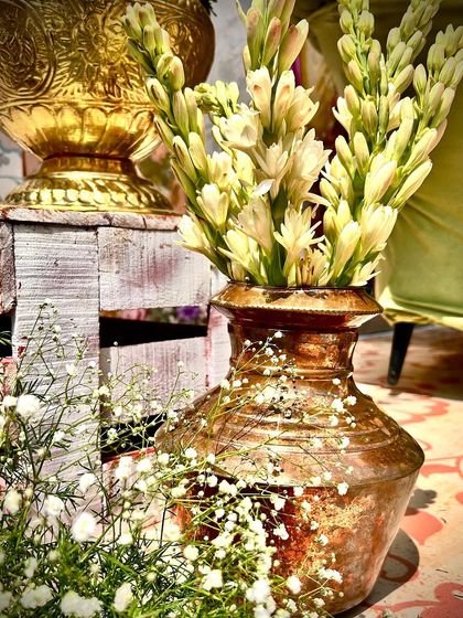A close-up of the traditional brass pot and tuberose flowers, details that add authenticity and elegance to a South Indian themed event.