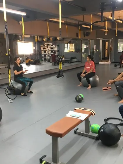 Students use stability balls for a core and balance workout. We teach how to use various functional training tools to create diverse and effective client programs.