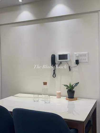 A close-up of the minimalist dining table setup. The clean lines and simple decor create a calm and uncluttered space for meals.
