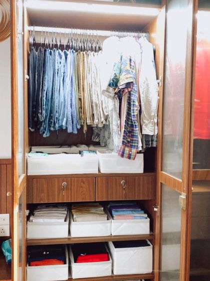 A beautifully organized men's wardrobe in a new home. We used bins for file-folding and kept the hanging space neat with uniform hangers.