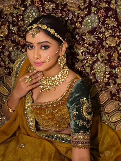 A regal portrait that showcases the bride's majestic presence. The makeup enhances her features without overpowering them, allowing her natural beauty to shine through.