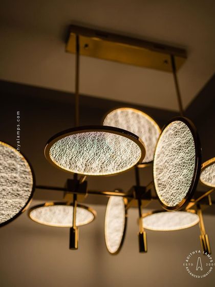 This angle highlights the warm, diffused light emitted from the textured discs, creating a soft and inviting ambiance perfect for a dining or living area.