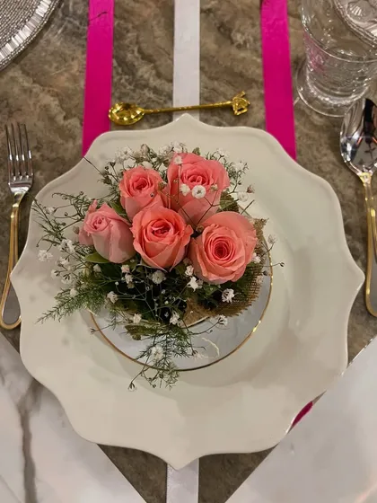 This elegant pink ribbon-themed tablescape is a perfect example of how I create a special mood for any occasion. The delicate floral centerpiece on the scalloped plate, paired with gold and silver cutlery, sets a tone of grace and celebration.