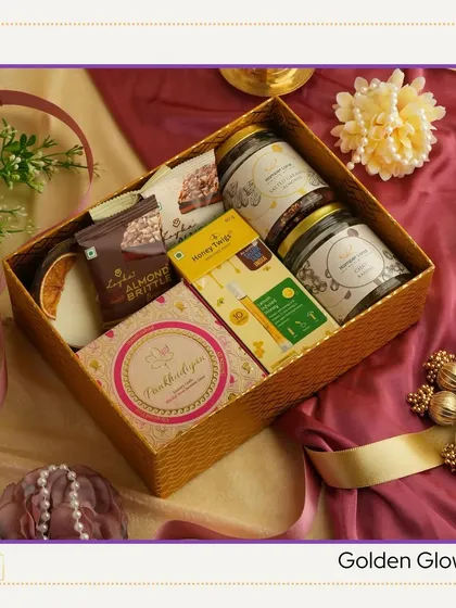 The 'Golden Glow' Diwali hamper. A beautiful gold-textured box filled with almond brittle, honey twigs, and other gourmet treats.