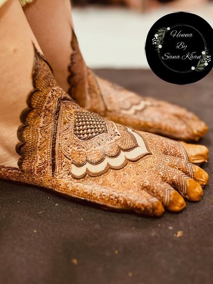 A classic bridal foot design, with detailed patterns covering the top of the foot and toes. The use of negative space creates a beautiful scalloped edge.