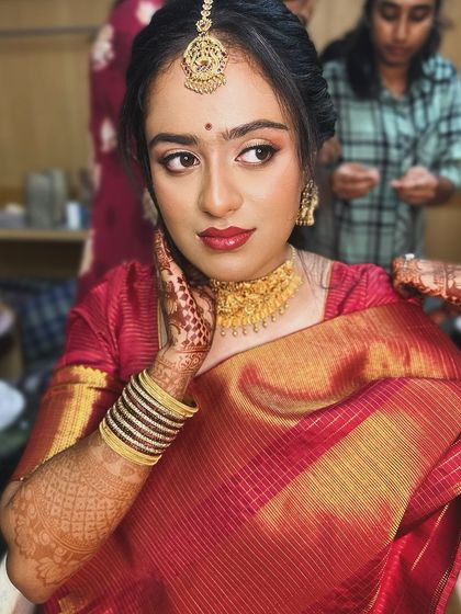 A behind-the-scenes shot of the bride getting ready, her makeup looking soft and beautiful.