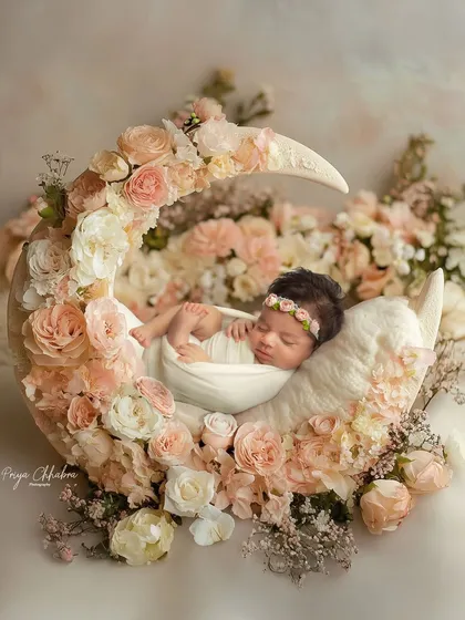 Cradled by the moon and surrounded by blossoms, this is where dreams begin. I love creating these fairytale setups to capture the pure magic of your newborn's first days.