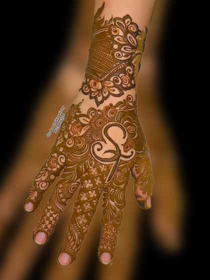 A modern and stylish design with a large 'S' initial as the centerpiece, surrounded by Arabic-style patterns.