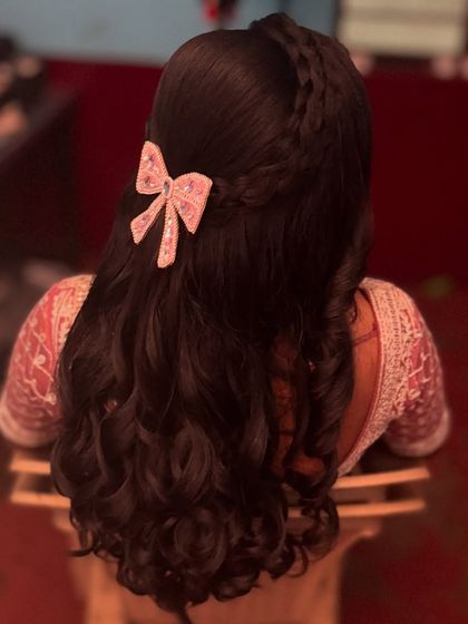 Another view of the romantic half-updo, showing the beautiful texture of the curls and the delicate braid detail.