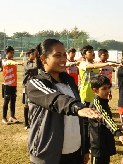 A coach leads the players in taking a pledge during Republic Day celebrations, combining patriotism with team activity.